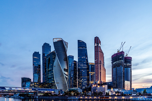 The Moscow International Business Center (Moscow-City) skyscrapers against blue evening sky.