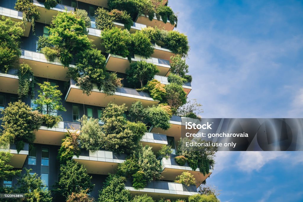 Sustainable architecture. Green futuristic skyscraper Bosco Verticale, vertical forest apartment building with gardens on balconies. Modern sustainable architecture in Porta Nuova district,  Milan, Italy. Green Building Stock Photo