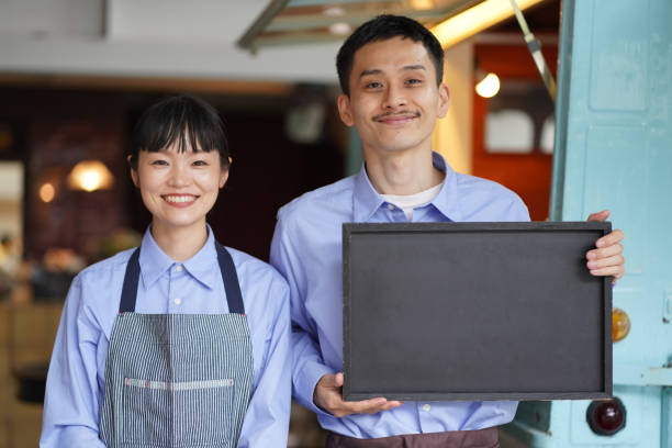 istock A couple holding a message board in front of a kitchen car 1323143922
