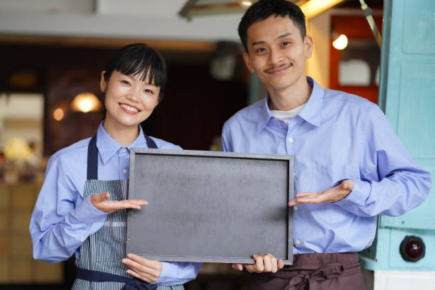 istock A couple holding a message board in front of a kitchen car 1323144024