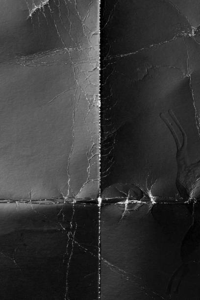 istock Wrinkled black old wrinkled paper. Dusty cardboard wrapping 1323148033