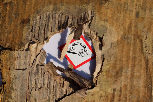 Warning sign on a corrugated iron wall with the inscription: explosive material authorized personnel only