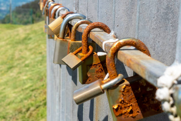 istock Old rusty love padlocks hanging on railing outdoors 1323148080