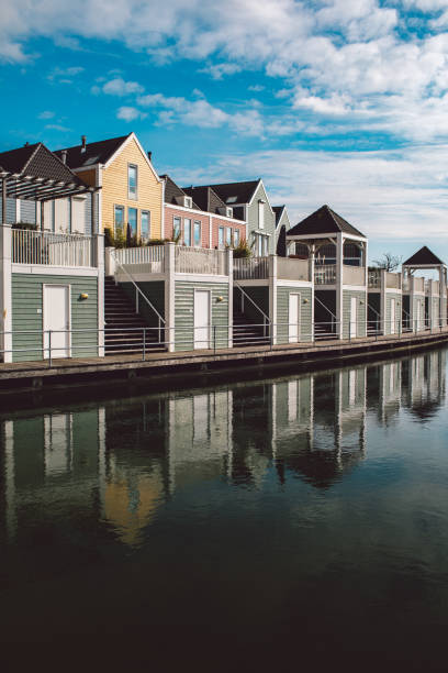 istock Buildings By River Against Sky 1323148833
