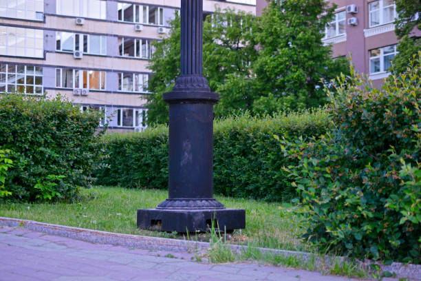 Iron lamp post in the old town among the plants