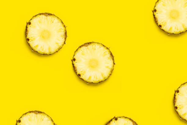 istock Pineapple slice against on a yellow background. Top view, flat lay 1323153141
