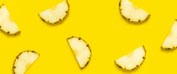istock Pineapple slice against on a yellow background. Top view, flat lay. Banner 1323153168