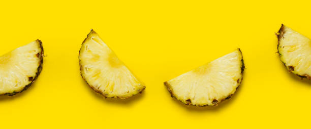 istock Pineapple slice against on a yellow background. Top view, flat lay. Banner 1323153174