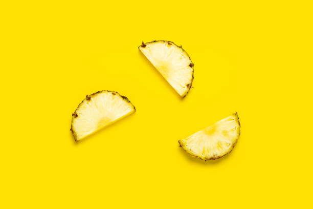 istock Ripe pineapple slices on a yellow background. Top view, flat lay 1323153214
