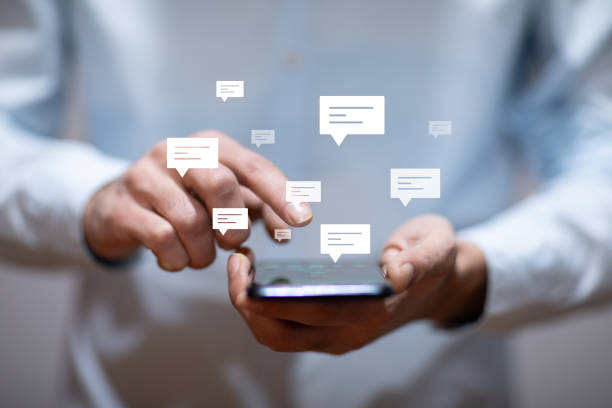 istock man holding smart phone with letter signs 1323157500