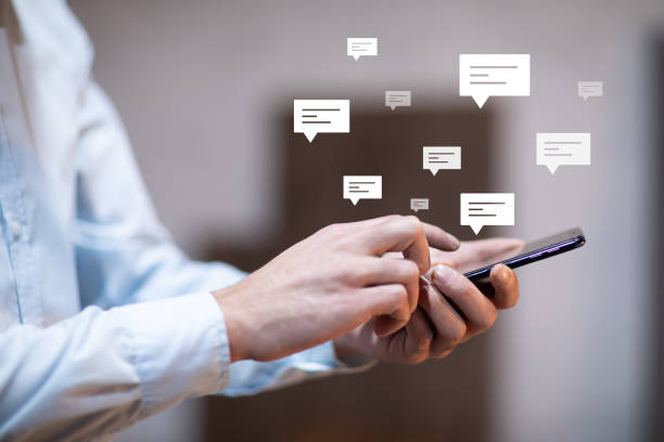 istock man holding smart phone with letter signs 1323157508