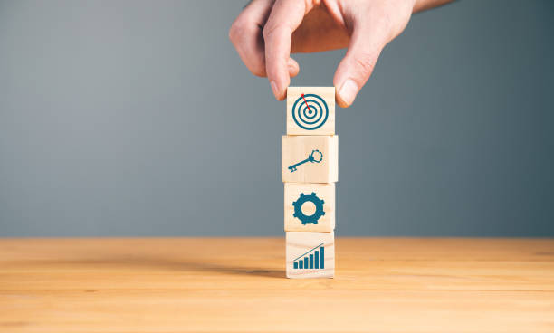 istock man holding cubes and goals 1323157517