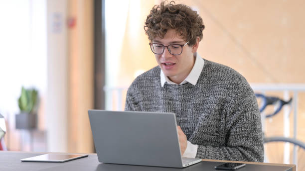 istock Online Video Chat on Laptop by Young Man at Work 1323157764