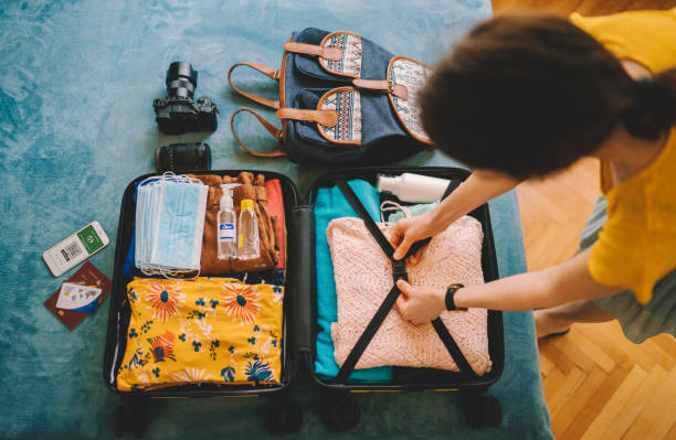 istock Woman packing suitcase for travel 1323158288