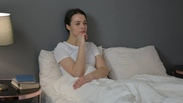 istock Pensive Young Woman Thinking  in Bed 1323158518
