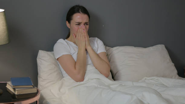 istock Upset Young Woman Crying in Bed 1323158570