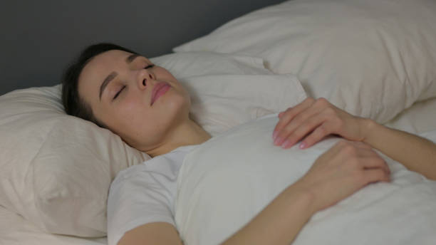 istock Peaceful Young Woman Sleeping in Bed 1323158731