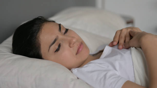 istock Young Indian Woman Sleeping in Bed 1323159497