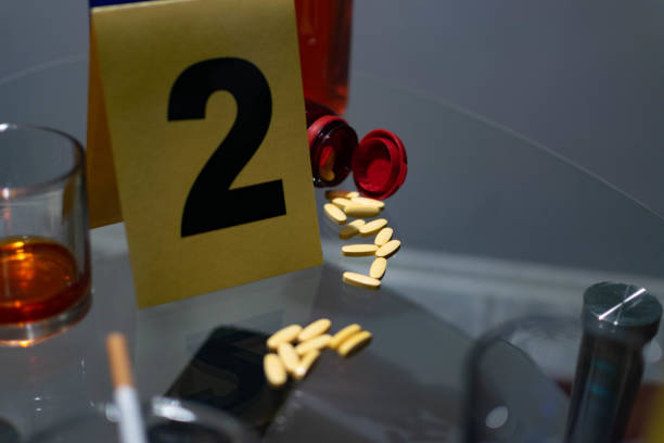 istock Forensic scientist, looking for the evidence on the crime scene, collecting fingerprints, photographing evidence, with his full protective suit, gloves, and forensic gear. 1323160030