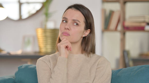 portrait of pensive young woman thinking at home - 3148 imagens e fotografias de stock