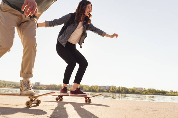 istock Young Couple practicing skateboarding outdoors 1323161822