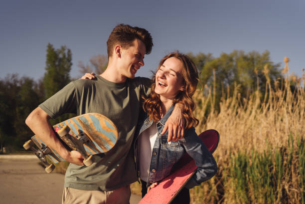 istock Young boyfriend with girlfriend on a date with skateboards 1323161862