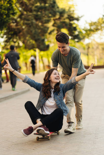 istock Young Couple practicing skateboarding outdoors 1323161958