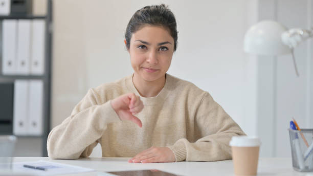 istock Thumbs Down by Young Indian Woman 1323163020