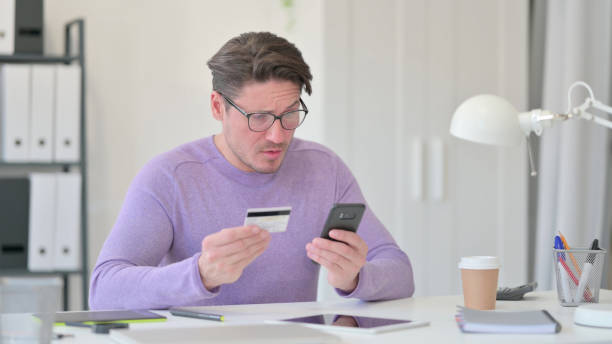 istock Online Shopping Failure on Smartphone by Middle Aged Man 1323163053