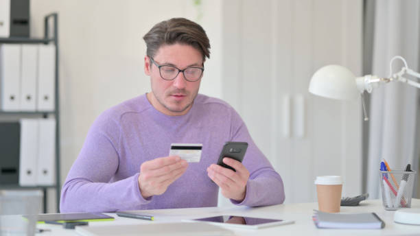 istock Online Payment on Smartphone by Middle Aged Man 1323163102