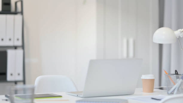 istock Empty Office Room with Laptop on Desk 1323163266
