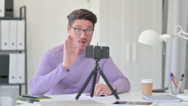 istock Man Blogging in Office, Video Chat 1323163282