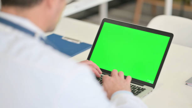 istock Male Doctor working on Laptop with Chroma Screen 1323163352