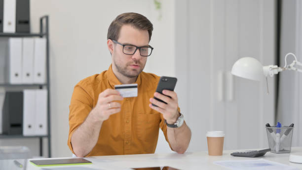 istock Online Shopping Success on Smartphone by Young Man 1323163418