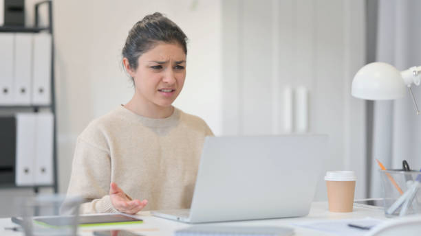 istock Tense Young Indian Woman Frustrated by Loss at Work 1323163542
