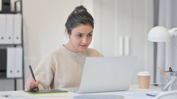 istock Young Indian Woman Drawing on Graphic Tablet 1323163550
