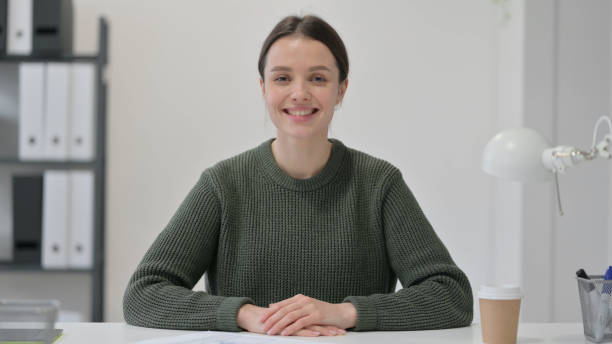 istock Young Woman Smiling at the Camera 1323163716
