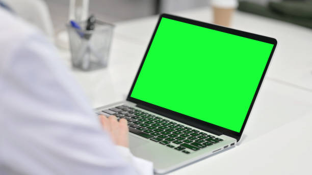 istock Young Woman using Laptop with Chroma Screen 1323164445