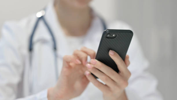 istock Female Doctor using Smartphone, Close up 1323164456