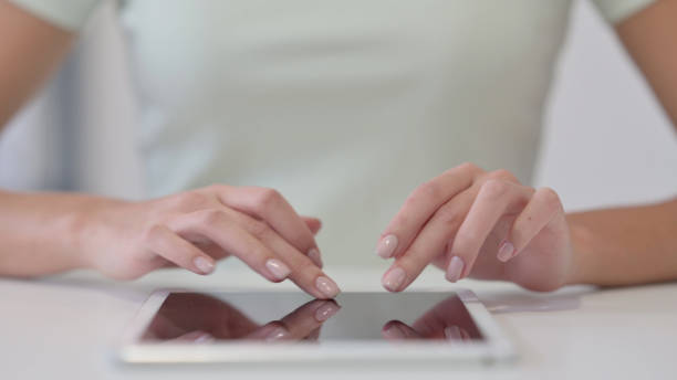 istock Close Up of Female Hands Using Tablet, Typing 1323164535