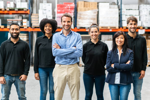 istock Portrait of warehouse manager with workers 1323164575