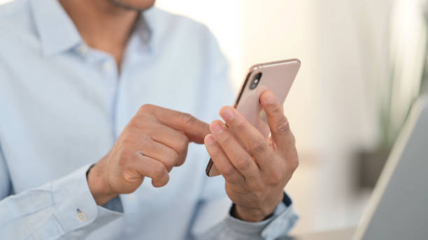 istock Close up of African Man using Smartphone 1323164770