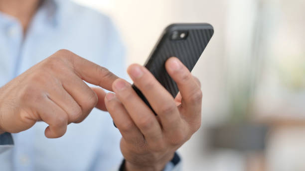 istock Hands of African Man using Smartphone, Close up 1323164798