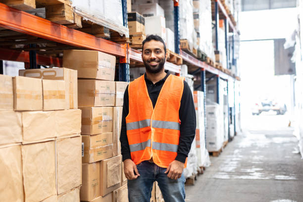 istock Happy warehouse worker in reflective vest 1323164876