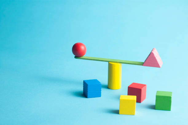 istock Minimal concept with a stick swingscale and colorful geometric figures 1323164972