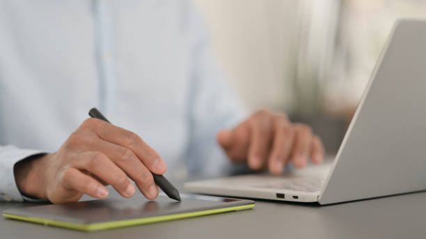 istock African Hands Designing on Tablet with Stylus, Close up 1323164982