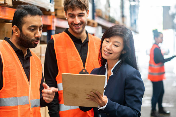 istock Warehouse in-charge discussing delivery plan with team 1323165231