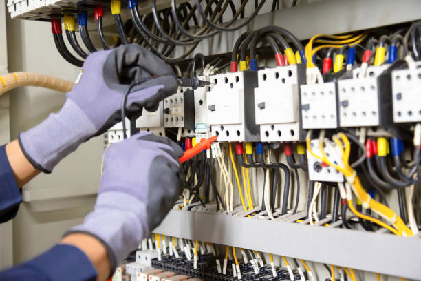 istock Electrician engineer tests electrical installations and wires on relay protection system. Adjustment of scheme of automation and control of electrical equipment. 1323166010