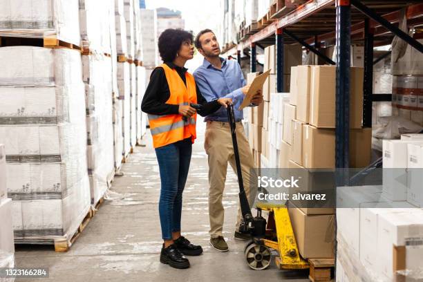 Worker Following Instructions Of Foreman At Warehouse Stock Photo - Download Image Now