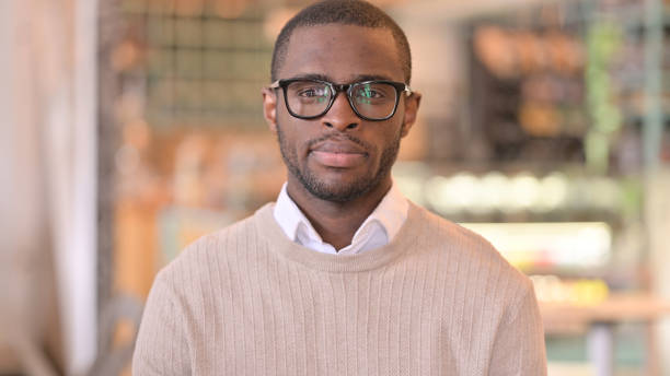 istock Portrait of Serious African Man Looking at Camera 1323166315